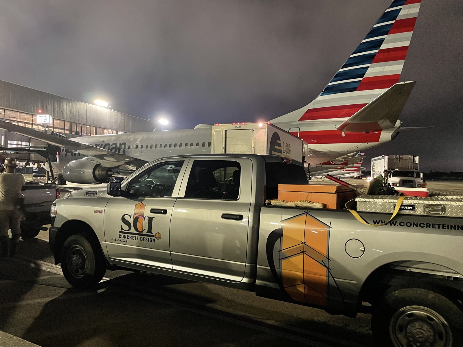 Company truck making a delivery on the airport tarmac at night