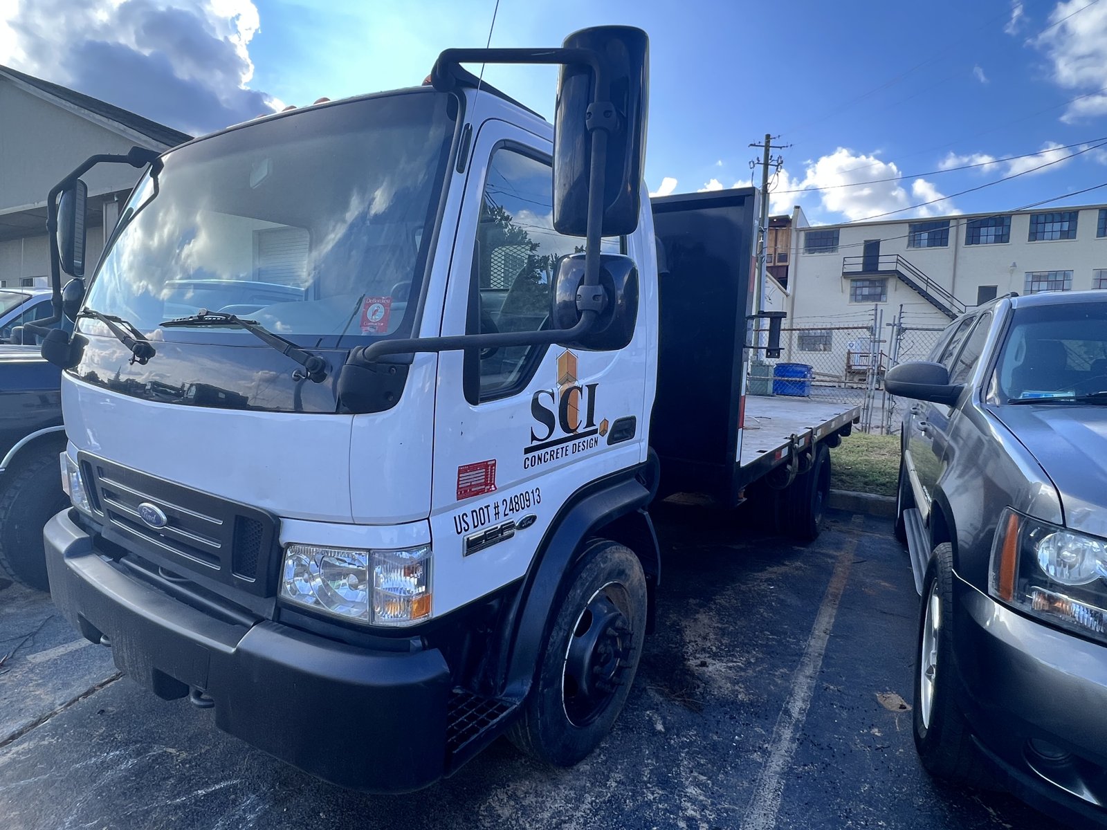 Company cabover flatbed truck for local equipment and material runs